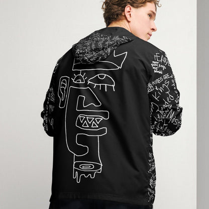 Person wearing a black hoodie with white graphics on a gray background
