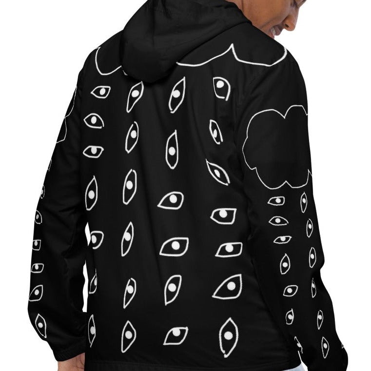 Person wearing a black hoodie with white patterns on a white background