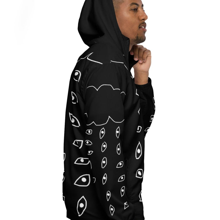 Person wearing a black hoodie with white patterns on a white background