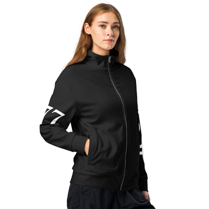 Woman wearing a black tracksuit with white branding on a white background