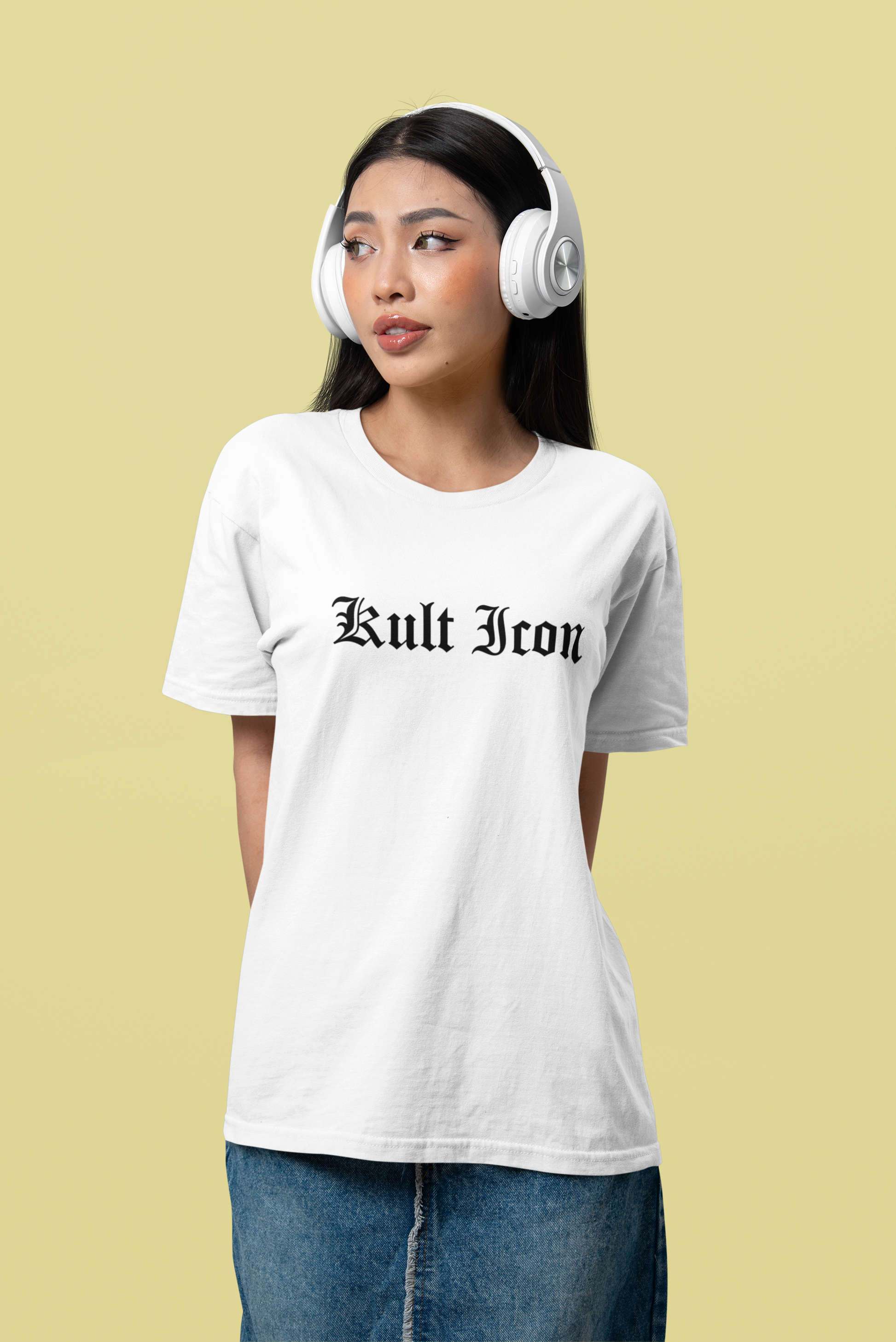 Woman wearing a white t-shirt with 'Kult Icon' text and white headphones on a beige background