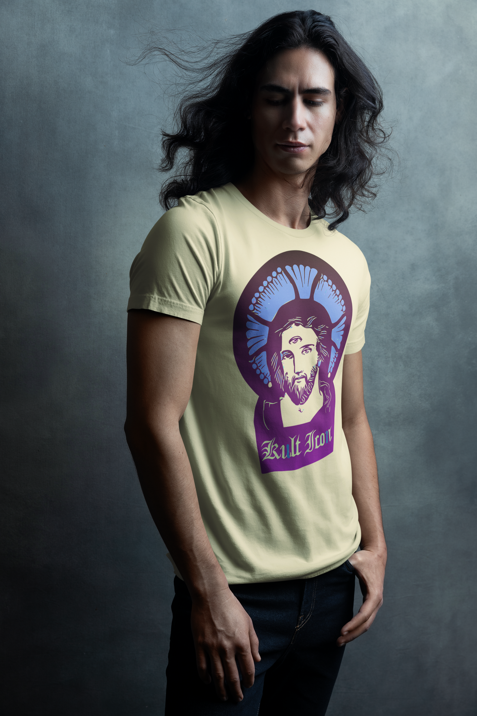 Person wearing a light yellow t-shirt with a graphic design on a gray background