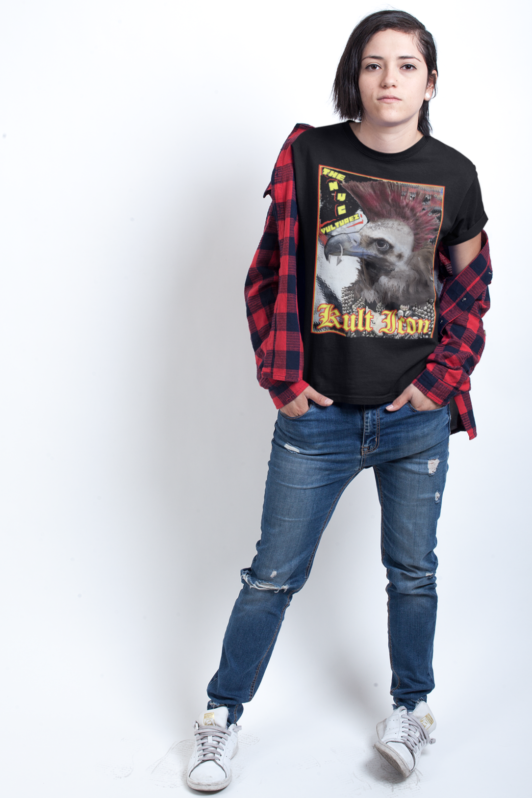 Person wearing a black graphic t-shirt, red plaid shirt, blue jeans, and white sneakers on a white background