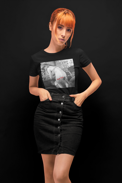 Woman wearing a black t-shirt with a graphic design on a black background