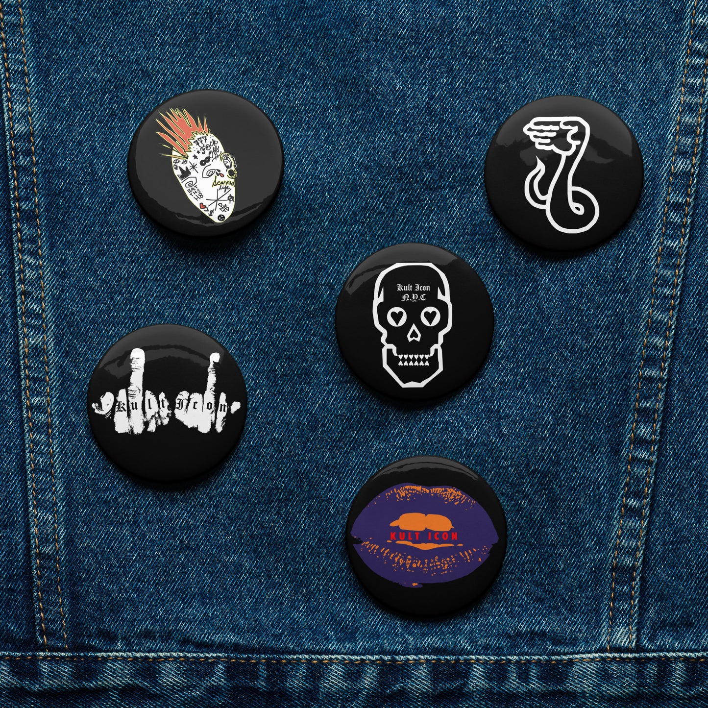 Set of six black buttons with various designs on a denim background